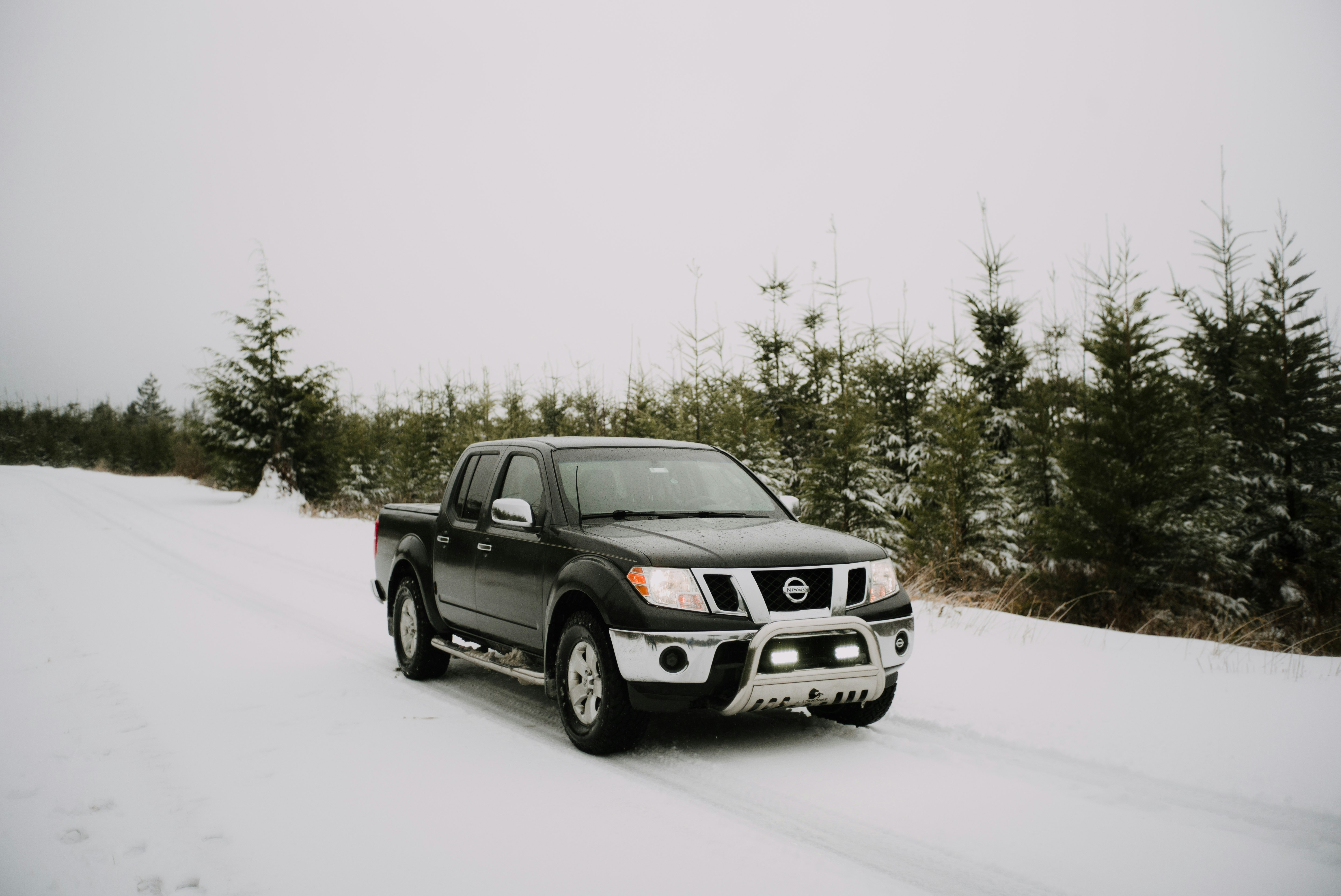 black ford suv on snow covered ground during daytime